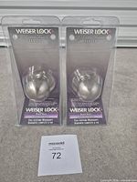 Front view showing two packaged Weiser Lock dummy knobs