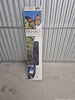 Front of Monarch flooring case showing branding and butterfly logo