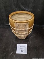 Front view of brown glazed ceramic plant pot with sisal wrap