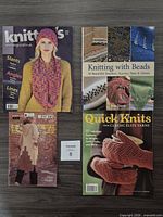 Top view of four knitting publications arranged on table