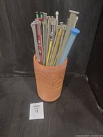 Needles standing inside terra cotta holder