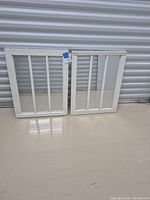 Both mirrored windows leaning against wall showing front view