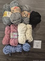 All 10 balls of yarn arranged by colour and brand