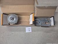 both boxes opened showing coil nails and assorted bolts, nuts, washers
