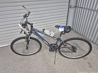 Full left side view of SporTek HT-26 mountain bike showing frame, wheels, water bottle, bull horn handles
