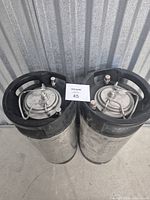 Top view of both Cornelius pin-lock kegs showing lids, posts and pressure relief valves