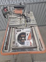 Ridgid wet tile saw on stand with new packaged 7-in blade on tray