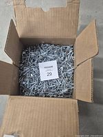 Open box showing large quantity of roofing nails