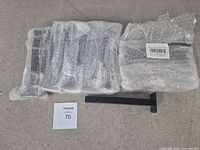 Brackets in bubble wrap with one bracket shown flat