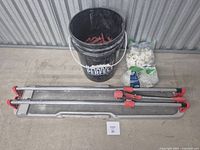 Tile cutter, bucket of wedges, two bags of clips overview
