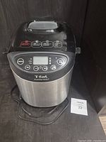 Front and top view of breadmaker showing control panel and exterior