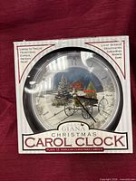 Front view of boxed Alan Giana Christmas Carol Clock