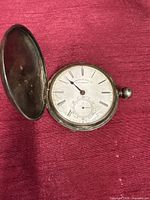 Front view with lid open showing dial and hands