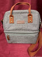 Front view of Lokass heather gray insulated lunch bag with handles and strap