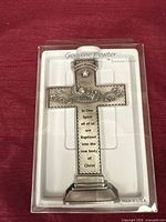 Front view of packaged pewter cross