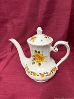 Full side view of Ridgway teapot with lid showing yellow rose pattern and gold trim