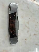 Knife closed showing wood handle and bolsters