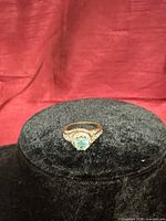 Ring on display, showing stone, setting and overall design