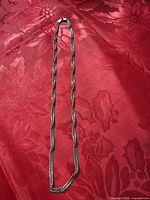 Full view of sterling silver curb chain necklace laid flat