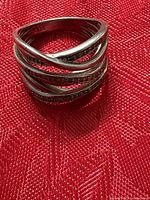 Ring front view showing crossover design and pavé bands