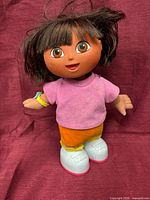 Front view of interactive Dora doll standing