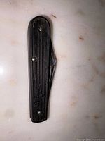 Knife closed showing handle texture and hardware