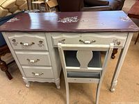 front view of desk and chair showing drawers, hardware and floral designs