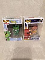 Front view of both boxed Funko Pop figures showing characters and numbering