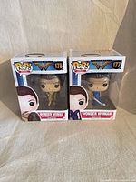 Front view of both boxed figures showing model numbers and characters