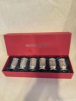 Open red Noblesse Pewter box displaying six pewter shot cups