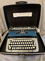 Typewriter inside open case showing overall condition