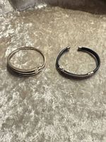 Both cuff bracelets side by side on fabric surface