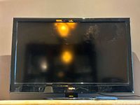 Front view of Sanyo flatscreen TV on stand