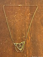 Full view of necklace laid flat showing chain and pendant