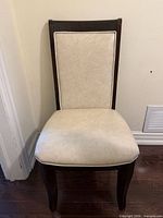 Front view of beige faux leather wood side chair