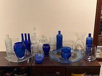 Full lot showing variety of clear and cobalt glass pieces
