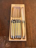 Six Laguiole steak knives in beechwood tray