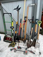 Group shot showing all garden tools, mower and sprinklers