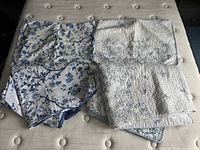 Overall view of duvet, quilt, and shams on mattress