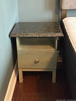 full view of nightstand beside bed