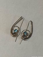 Both earrings front view showing design and stones