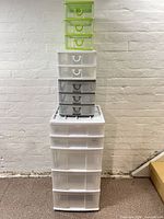 stacked view of five plastic drawer units showing sizes and colors