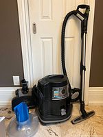 Overview of vacuum motor unit, hose, wand, water basin and attachments