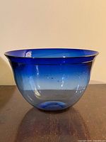 Side view of cobalt and clear art glass bowl