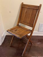 Front angled view of acacia wood folding chair