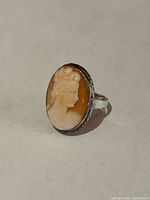 Front view showing carved cameo portrait and silver bezel