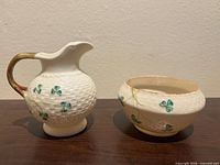 Pitcher and sugar bowl front view showing pattern and form