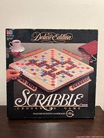 Front of boxed Scrabble Deluxe Edition