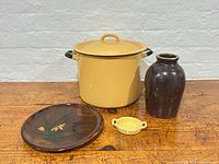 All four items: yellow enamel pot with lid, brown crock jug, lacquered plate, small yellow dish