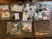 Overview of all bagged components, cables, and boxed divider of connectors on tables
